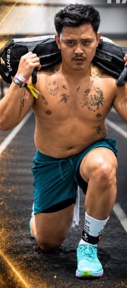 Athlete doing sandbag lunges on a track
